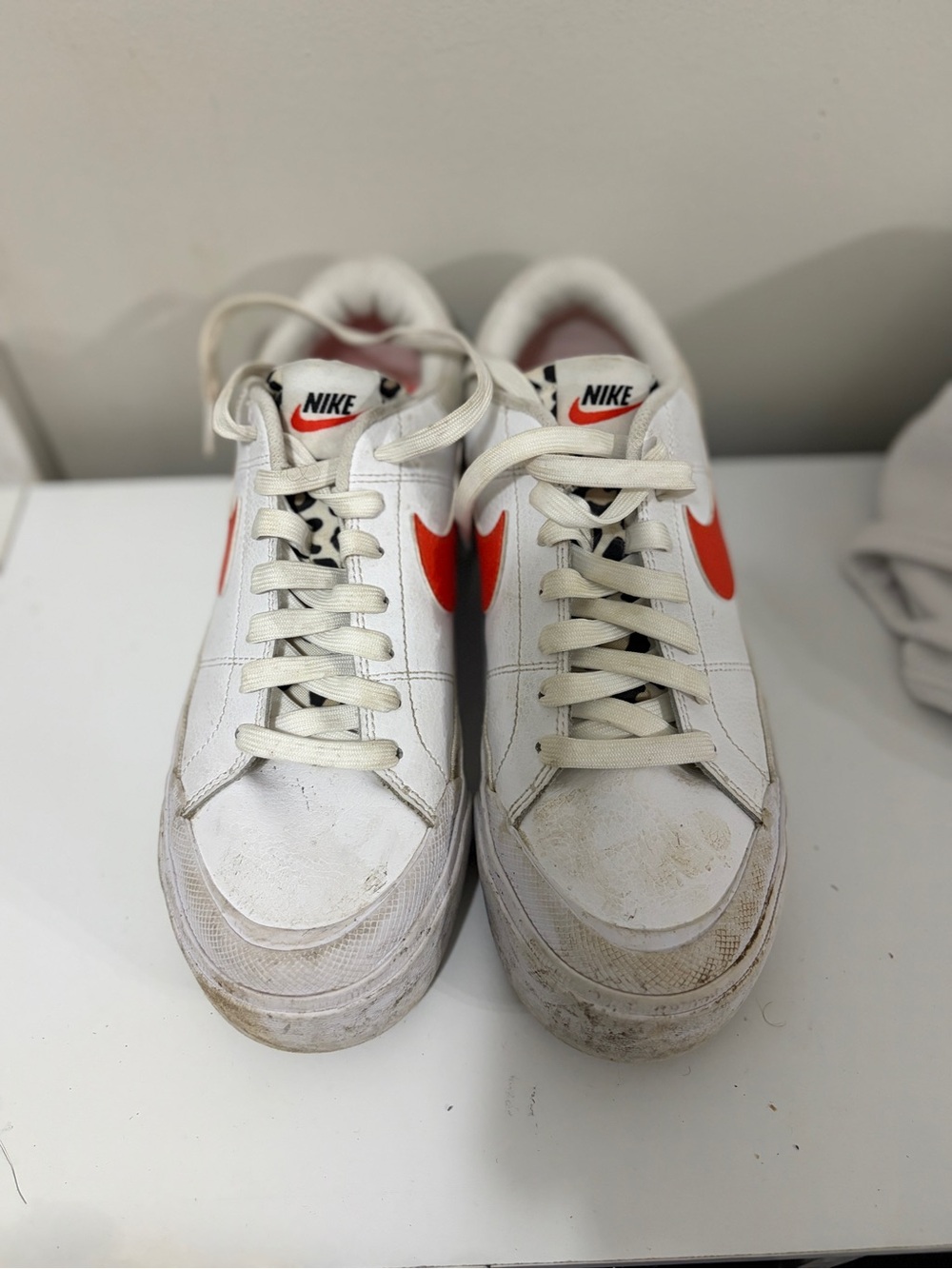 Nike Women’s White Sneakers with Orange Swoosh